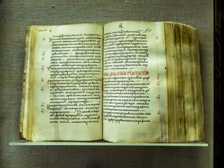 old opened ancient book close up on the shelf