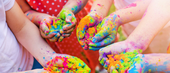 Paint holi on the hands of children
