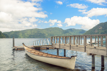 Naklejka na ściany i meble Wooden boat pier on mountain lake