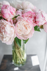 Lovely flowers in glass vase. Beautiful bouquet of white and pink peonies . Floral composition, daylight. Summer wallpaper. Pastel colors