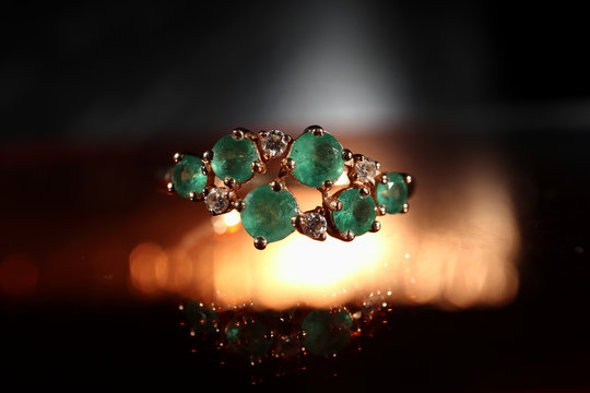 Women's ring made of gold with emeralds close-up