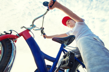 Fototapeta na wymiar Boy rides a bicycle on the waterfront.