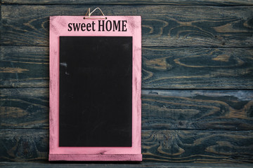 Obraz premium Blackboard with Text Sweet Home in Pink Wooden Frame