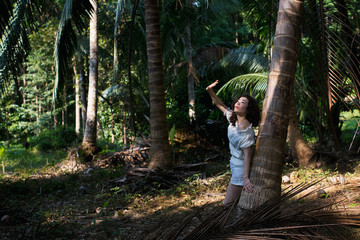 Pretty young woman of mixed race in the tropical forest..