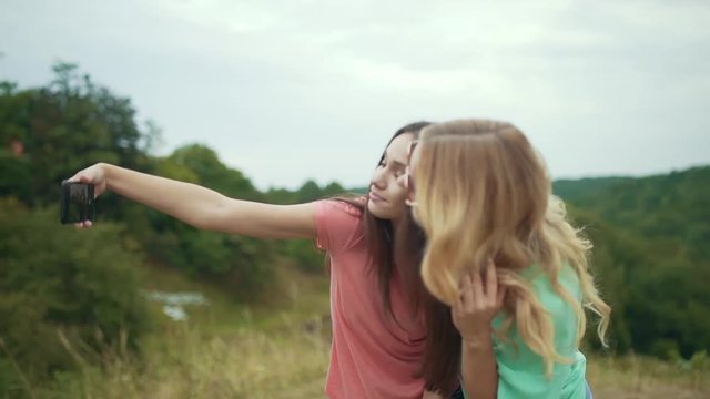 Beautiful Girls Taking Photos On Phone In Nature.