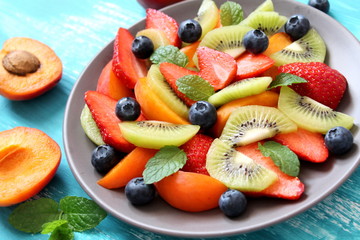 Plate with healthy fruits salad. Top view. Healthy food concept.