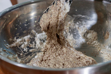 cocoa cake batter in silver bowl