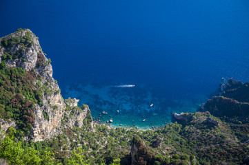 Fototapeta na wymiar Scenic view of the dazzling Mediterranean blue waters from the dramatic clifftop mountain coastline of the island of Capri, Italy 