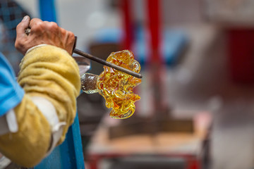 Pocos de Caldas, Minas Gerias/Brazil. Man shapping a crystal glass handicraft piece