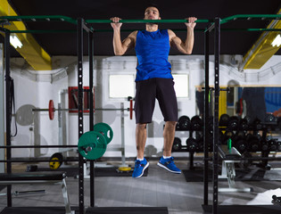 man doing pull ups on the horizontal bar
