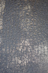 Old felt roofing tar fragment as an abstract background