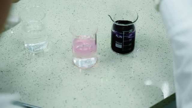 Laboratory concept, person close up dropping solute by measure to glass. The process of making tests in water or scrutiny expertise of analysis. The scientist chemist testing the chemical material