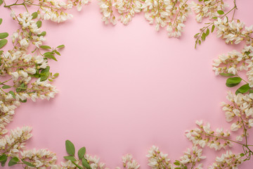 Spring floral background, textures and wallpaper. Flat white flower flowers on a light pink background, top view, copy space. Festive greeting card for women or wedding invitation