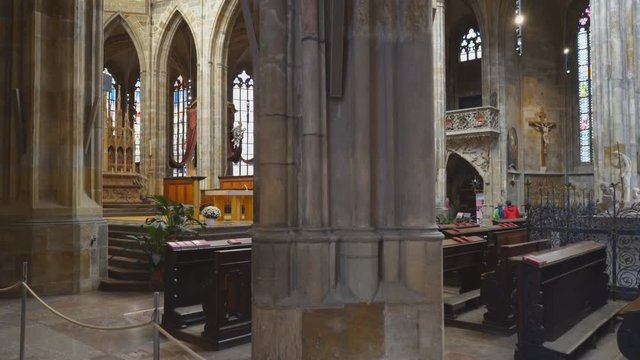 multi-axis gimbal stabilizer clip walking past a column in st vitus cathedral in prague, czech republic