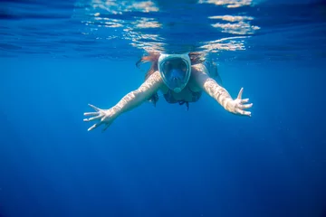 Fotobehang Snorkeling girl in full-face snorkeling mask undersea. Woman swimming © Elya.Q