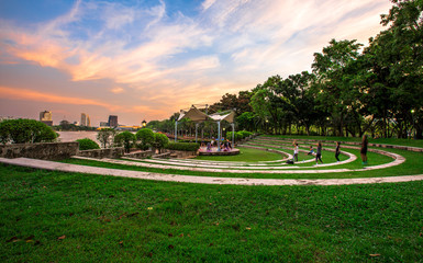 Evening at the park in the heart of Bangkok. People have to sit and exercise for good physical health. And fresh air (Benjakitti Park)