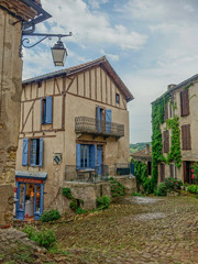 Cordes Sur Ciel, Midi Pyrenees, France - July 19, 2017: Typical narrow street of the village Cordes-sur-Ciel in Occitania