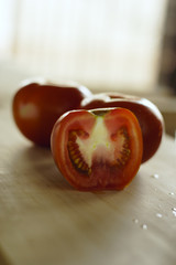 Sliced tomatoes in cutting board