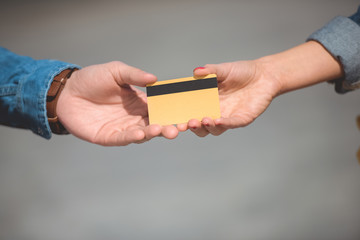 cropped shot of male and female hands with credit card