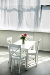 bouquet of tulips on table in modern light kitchen