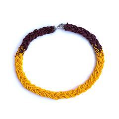 Bright handmade necklace braid from orange beads.