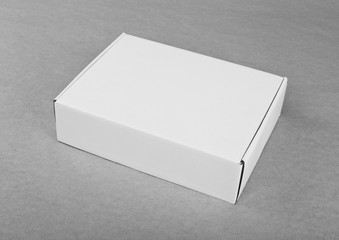 Closed white cardboard box for packaging on a white background.
