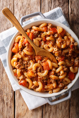 Homemade American goulash with elbow pasta, beef and tomatoes close-up. Vertical top view © FomaA
