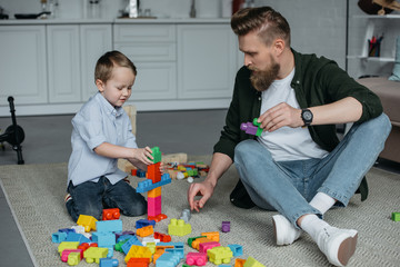 family playing with colorful blocks together at home