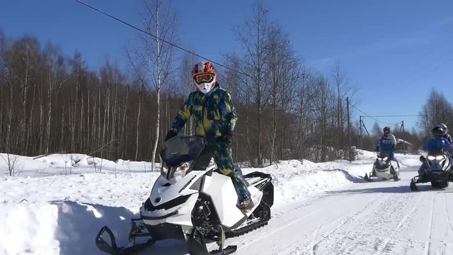 Snowmobiles go on the road