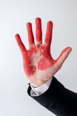 cropped image of businessman showing hand in blood isolated on white