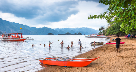 BUSUANGA PHILIPPINES - MARCH 29, 2018 : View of playing children at Busuanga against of Coron...