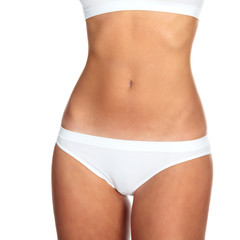 Fototapeta na wymiar Closeup shot of slim female body against a white background, isolated