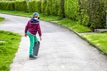 Fototapeta premium Little urban boy practicing with skateboard.
