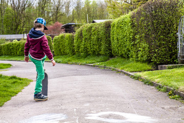 Fototapeta premium Little urban boy practicing with skateboard.
