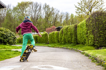 Fototapeta premium Little urban boy practicing with skateboard.