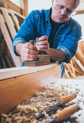 Carpenter At Work Using Jointer Plane