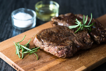 Grilled beef steak with rosemary, salt and pepper