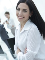 successful young business woman on the background of a workplace