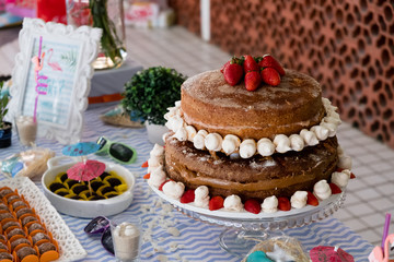 detail of strawberry and meringue naked cake, seen from above, 3 stories high..