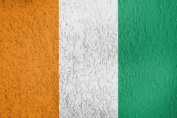Fototapeta premium Texture of Côte d'Ivoire flag on the wall of the plaster. 