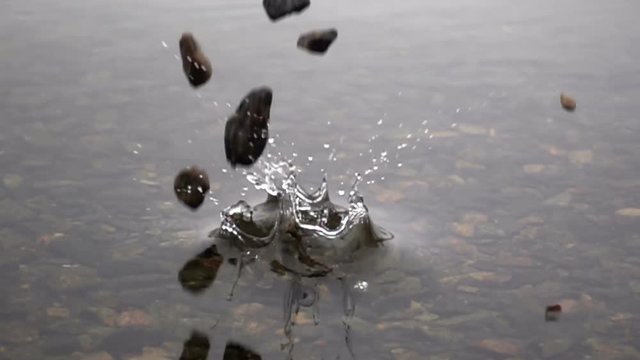 Slow Motion Video of Heap of Stones Falling in Water with Splash