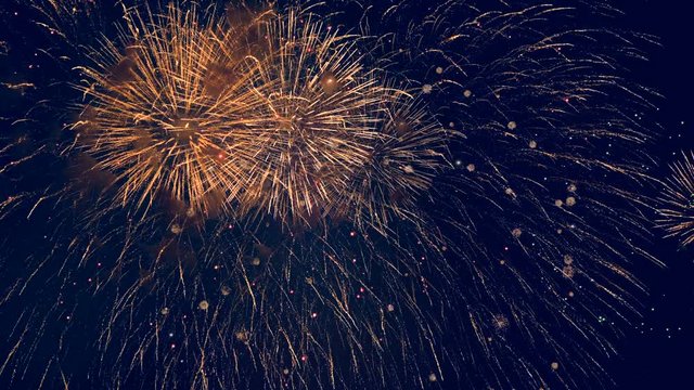 Lots of colorful bursts in a night sky. Multicolored fireworks burst, during a patriotic holiday.