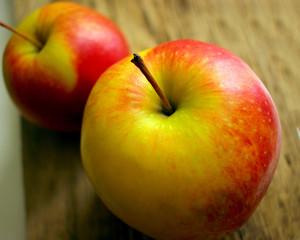 two juicy ripe apples on the background of an old wooden table close-up