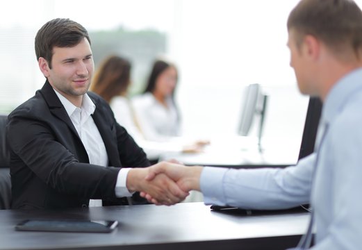 handshake business partners at your Desk