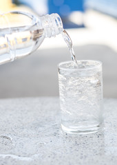 The water is in a clear bottle with a glass of ice. Water with Ice suitable for summer season.