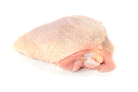 Raw chicken thigh isolated on white background.