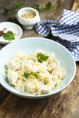 Homemade Russian dumplings served with parsley