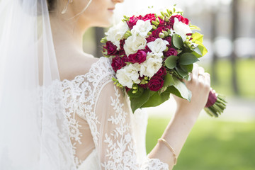 the bride is holding a wedding bouquet on her shoulder