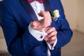 the groom is dressed in a blue suit and zap up the white shirt. The morning of the groom,
