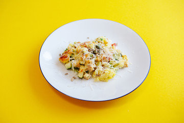 white plate with potatoes and vegetables on yellow table